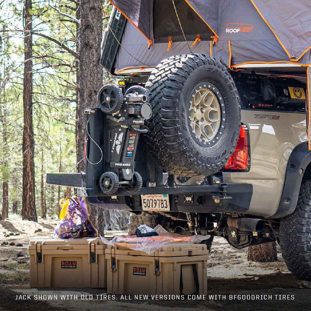 2 Ton Big Wheel Off Road Jack mounted on the back of a jeep in a forest setting.