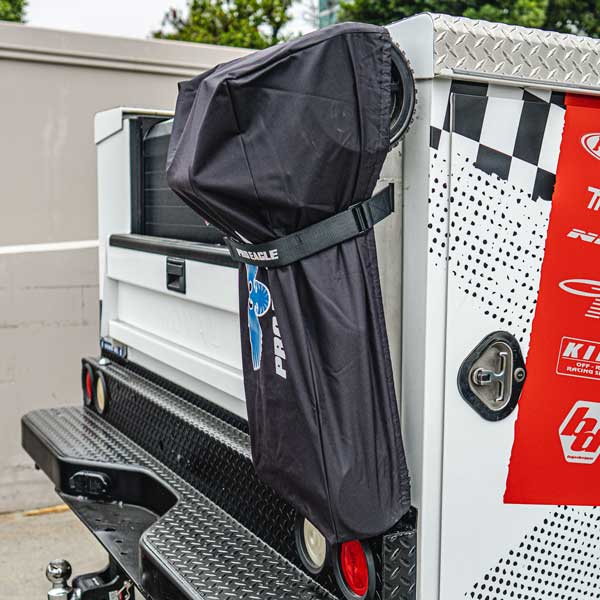 Black jack cover strapped to the side of a utility truck's tool compartment.