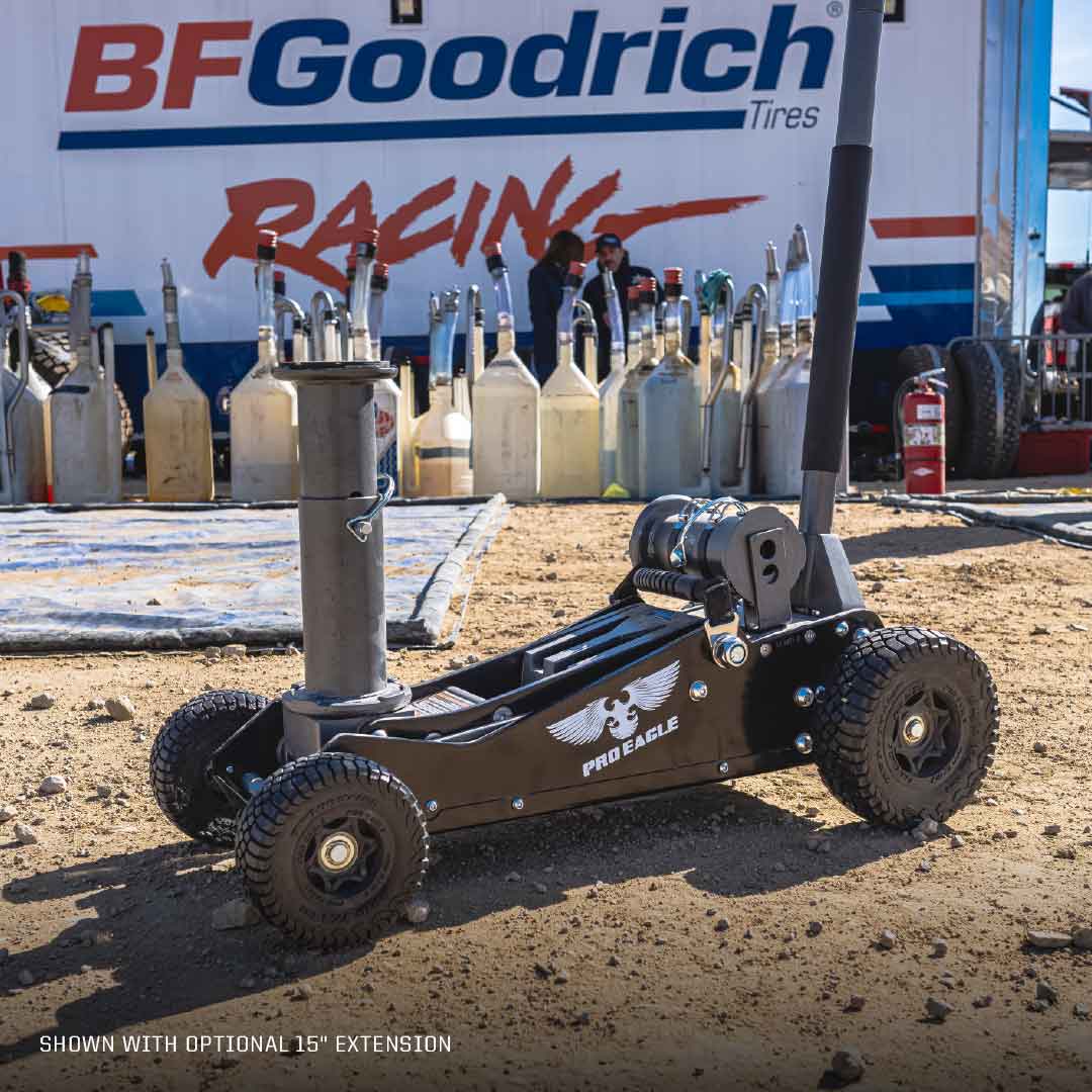 3 Ton Big Wheel Off Road Jack "Kratos" on dirt with racing equipment and BFGoodrich Tires banner in background.