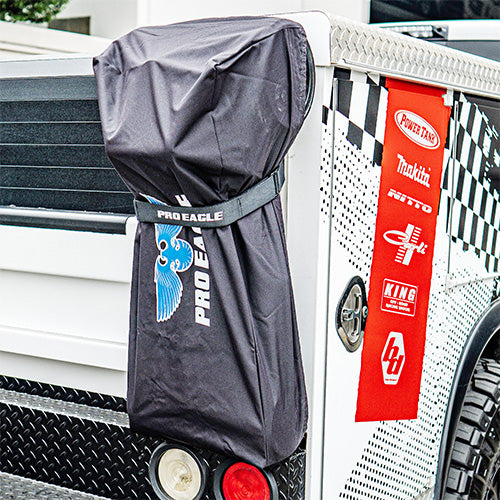 32" anti rattle strap attached to a covered jack on a truck's tailgate, showing brand logos.