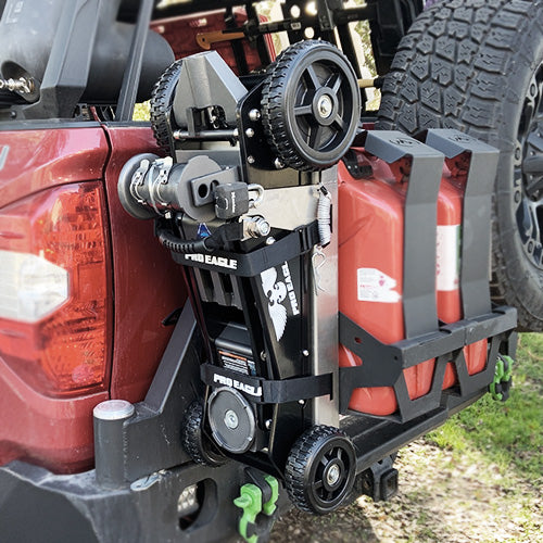 3 Ton Kratos Jack Mount 2.0 attached to a red vehicle's rear, alongside spare wheel and tools.