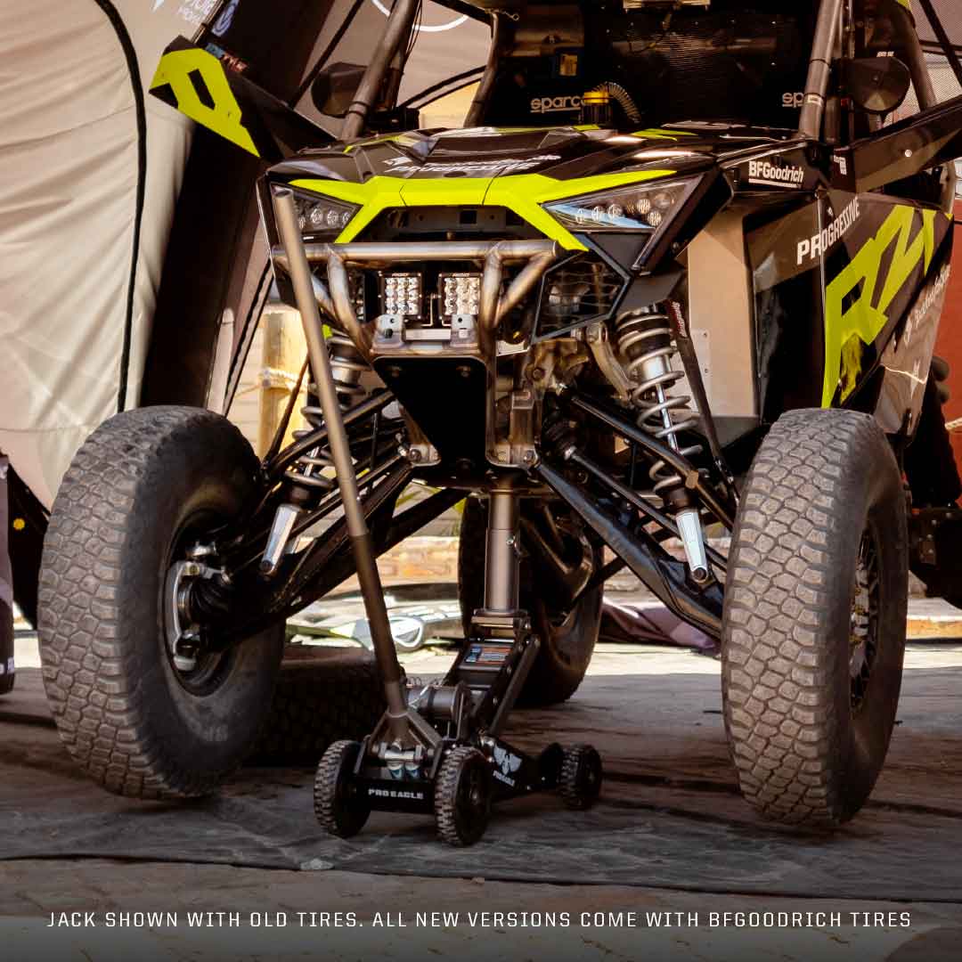 3 Ton Big Wheel Off Road Jack "Kratos" positioned under an off-road vehicle with large tires.