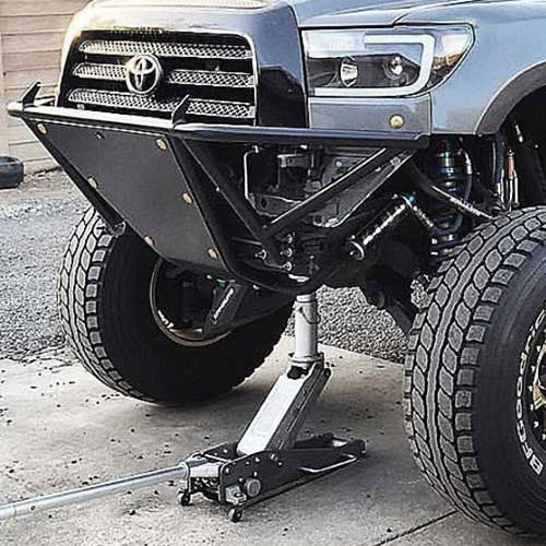 2 Ton Off Road Jack lifting the front of a Toyota truck with large tires